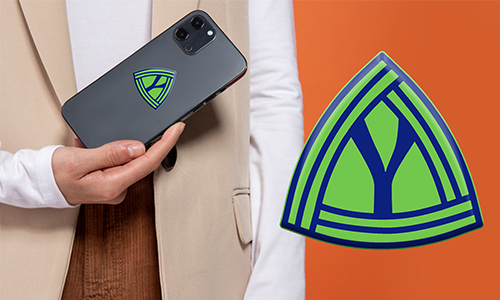 Person hält Smartphone mit personalisiertem grün-blauem Dreieck-Logo – passendes Emblem auf orangefarbenem Hintergrund.