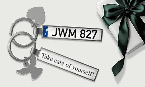 Personalized license plate keychain with heart and wing charms