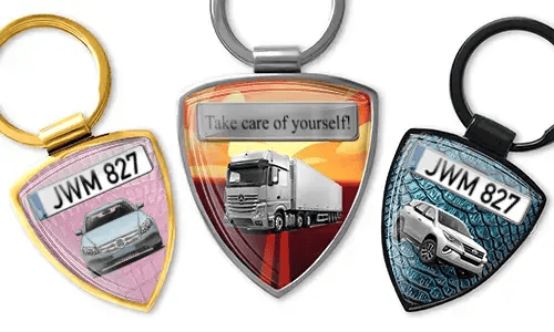 Shield-shaped photo keychain with car and truck designs