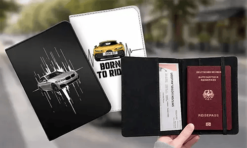 Three passport holders: black with silver car, white with yellow car and BORN TO RIDE text, right open showing German passport and boarding pass