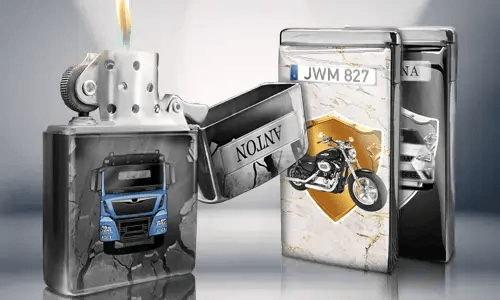Open metal lighter with a blue truck design, flame lit. Behind are two closed lighters with images: a motorcycle and a car with license plates.
