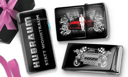 Three black and silver car-themed cigarette cases with dynamic graphics. One reads 