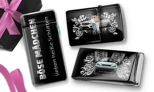 Three shiny black objects with car-themed designs. One reads 