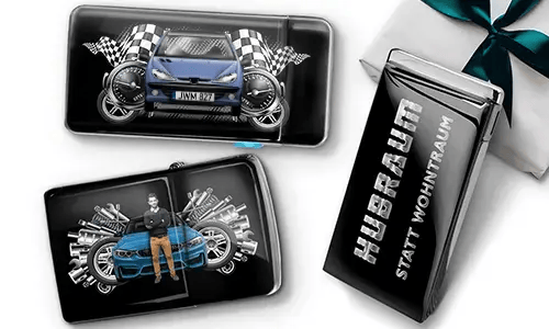 Geschenkset mit Auto-Themen-Metallbehältern, die Bilder eines grünen Sportwagens, karierten Flaggen und Motor-Motiven zeigen. Enthält ein Zigarettenetui mit der Aufschrift „Hubraum Statt Wohntraum“.