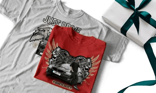 Two T-shirts, one white with JUST DRIVE and winged car, one red with BORN TO DRIVE and person