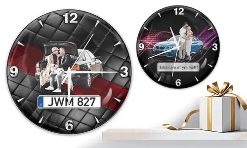 Two wall clocks with family and car scenes: left with trunk picnic on quilted background, right with blue sports car and couple over purple wave