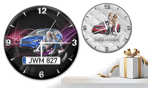 Two wall clocks with couples and cars: left with blue car and purple waves, right with red car on quilted white background